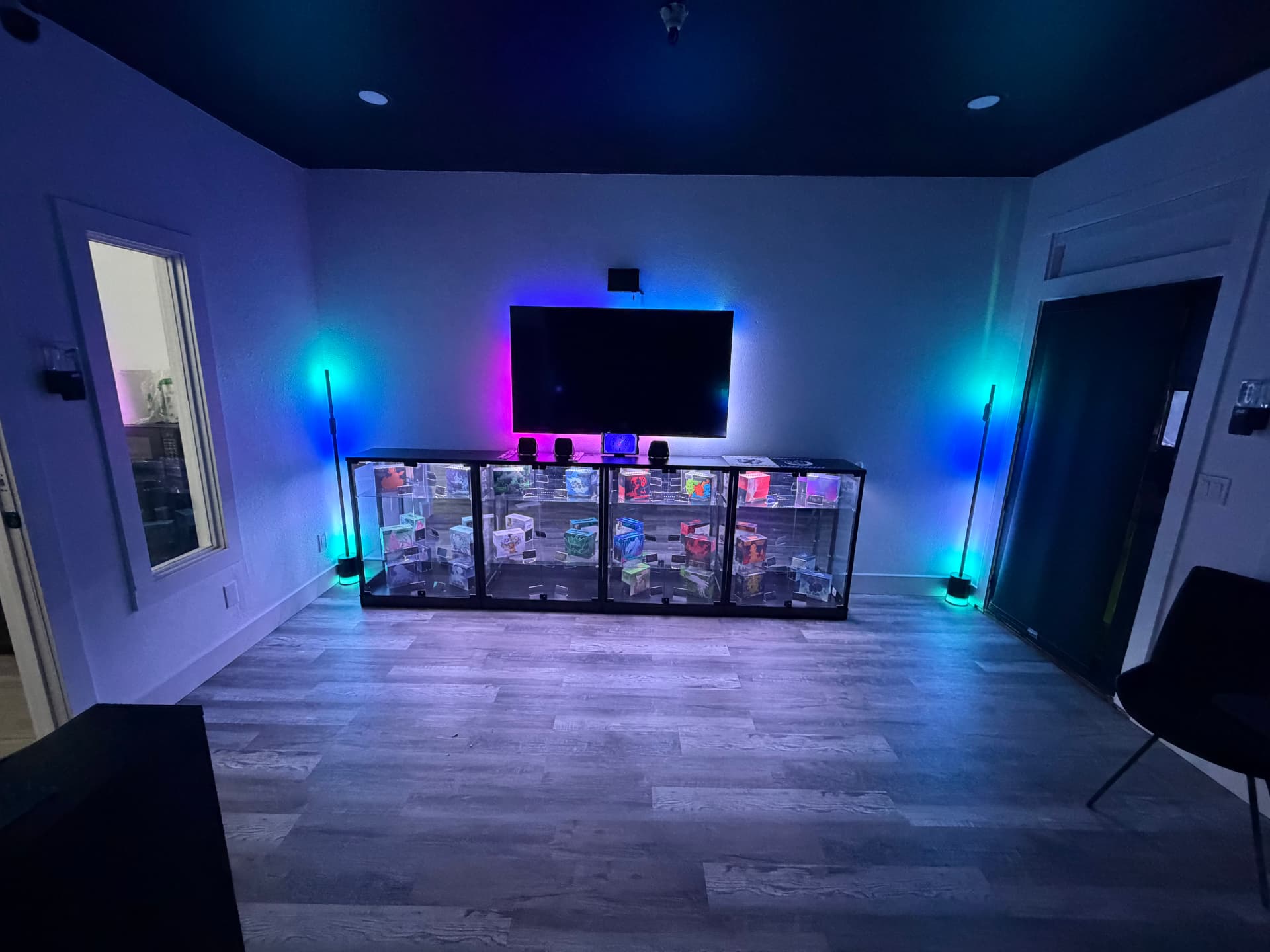 Glass display cases under a wall-mounted screen