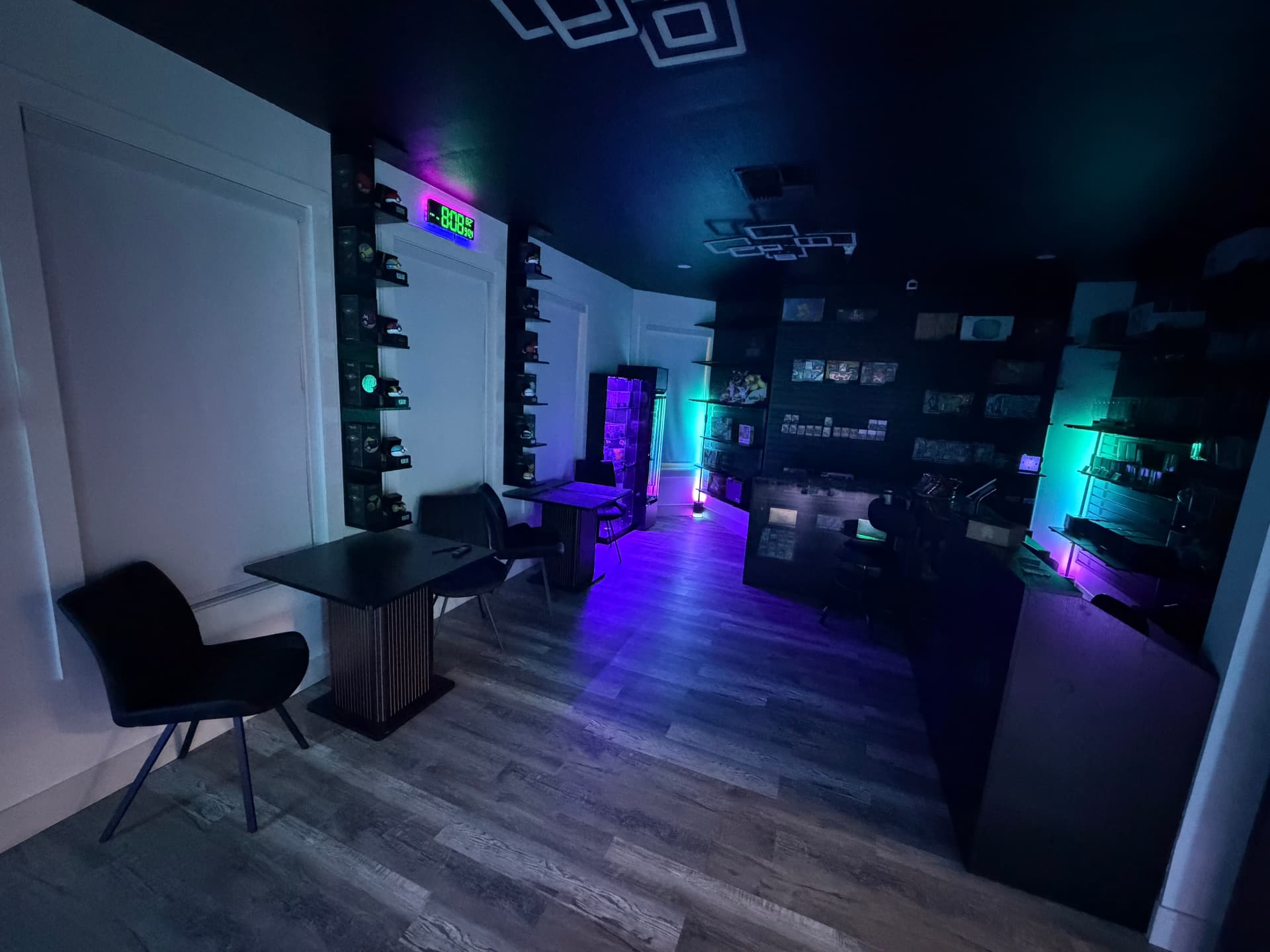 Play tables and chairs lit with colored LED lighting inside the shop
